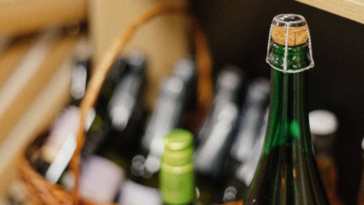 Бутылка шампанского на фоне других бутылок в магазине.